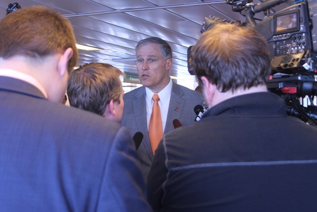 Gov. Jay Inslee answers questions posed by local television crews during a trip aboard the Tokitae on April 22. The visit was part of his push for a transportation package in the biennium budget.