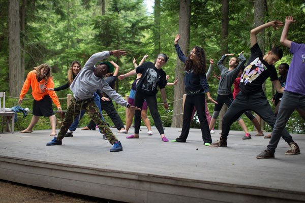 Campers dance on stage of the Chinook lands next to the Whidbey Institute during Power of Hope Camp