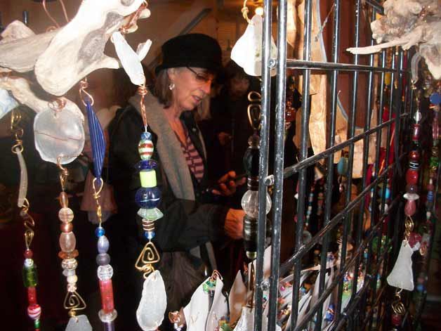 Connie Lloyd of Greenbank decides on which suncatcher to purchase at Linda Sullivan’s booth at the Bayview Holiday Market.