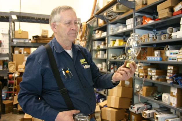 School district electrician Art Pratt examines a large