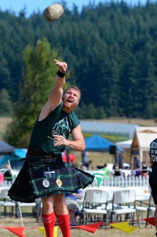 Garth Safford of Graham lobs a rock in the open stone competition at the 16th annual Whidbey Island Highland Games on Saturday at Greenbank Farm.