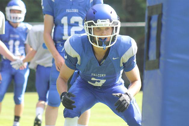 South Whidbey senior defensive back Connor Antich demonstrates a key step in a new tackling technique being implemented by the Falcons during a practice Monday afternoon. By keeping their eyes up