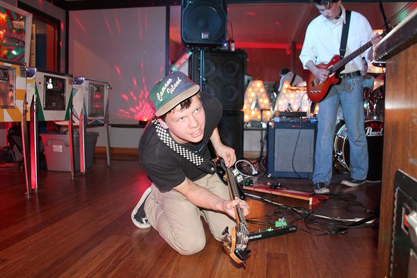 The Furries bassist Emrys Harper jams from the floor at The Machine Shop during the closing set of the Oct. 1 show. The Langley pinball arcade hosts concerts on the first Saturday of each month.