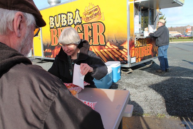 Ben Watanabe / The Record Greenbank residents Rob and Leslie Born enjoy the Friday special of fish tacos from Bubba Flame Broiled Burger truck in Freeland on Friday. Not frequent food truck diners