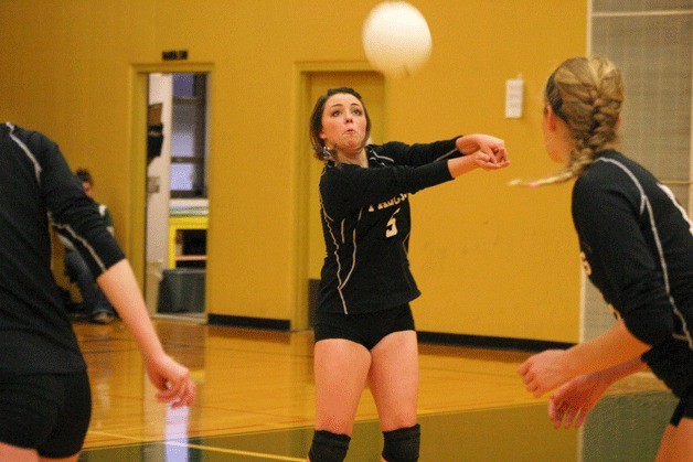 Falcon senior defensive specialist Justina Mackie-Timmerman passes against Burlington-Edison as teammate senior Jessica Manca positions herself.