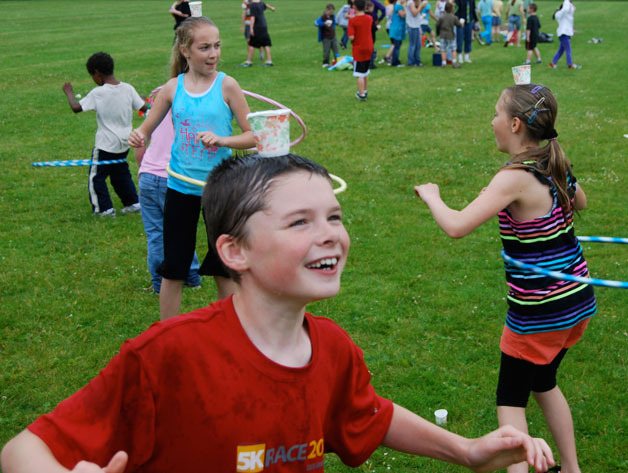 Michael Maddux balances a cup of water on his head while hula hooping during field day last week at South Whidbey Elementary School. Behind Michael are Ainsley Nelson (left) and Mary Zisette. Field day annually celebrates the coming end of the year for the Orcas.  The school year ended Tuesday on South Whidbey.