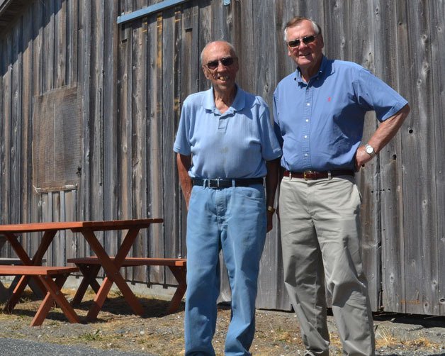 Warren Farmer and Bill Haroldson stand in front of the boathouse of a former fishing resort called Hap’s Resort. The resort was owned by Farmer’s aunt and uncle.