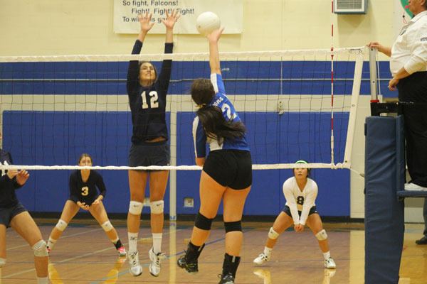 South Whidbey junior Kacie Hanson attempts a kill with Cedar Park Christian’s Chloe Biscup in contention.