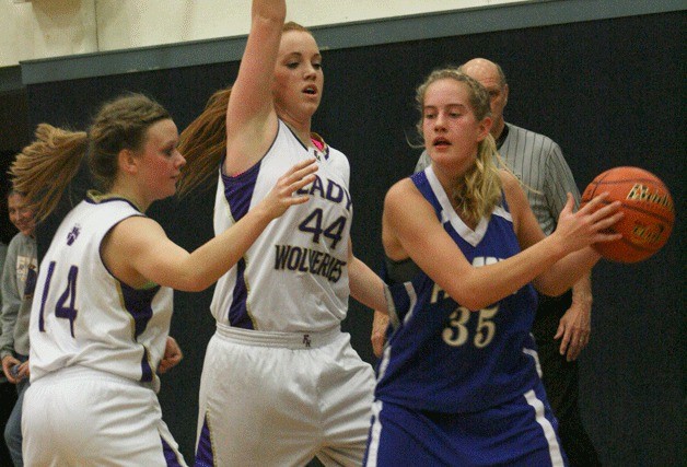 Hayley Newman tries to break the Wolverines' trap defense Saturday in Friday Harbor. The Falcon junior became ill during the 41-35 loss.