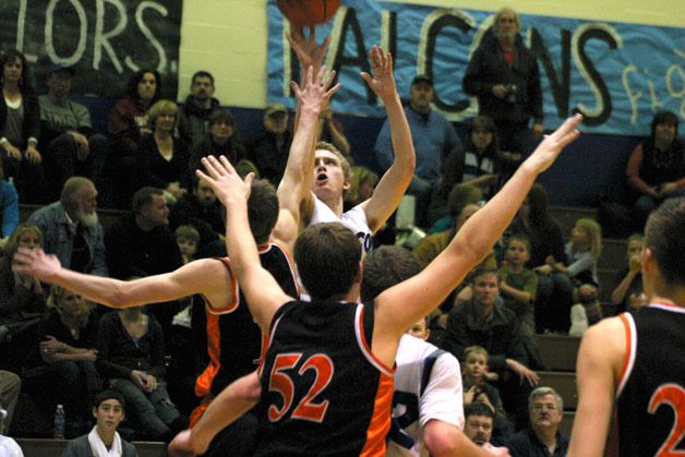 Sam Lee hits a jump shot over Tiger senior guard Shawn Madigan on Friday night. Lee scored eight points.