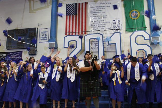 South Whidbey High School’s class of 2016 throw their caps in the air. Standing in front is Cameron MacDonald moments after he performed “Amazing Grace.”