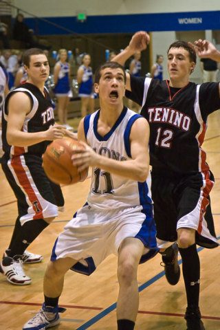 Falcon Chris Carey gives his all to make the shot Saturday as Tenino defender Jordan Howell gets ready to pounce. The boys won 68-38