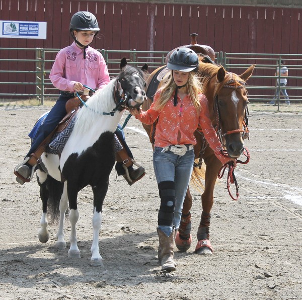 These girls walk through the horse arena during the Whidbey Island Area Fair before the events and competitions began.