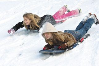 Zoe and Kayla Gran race down a hill at Community Park in Langley on Sunday.