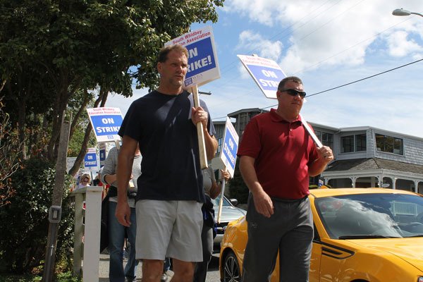 South Whidbey High School teachers Mark Eager and Tim Durbin march along the streets of Langley in protest of the district's recent collective bargaining agreement offer.