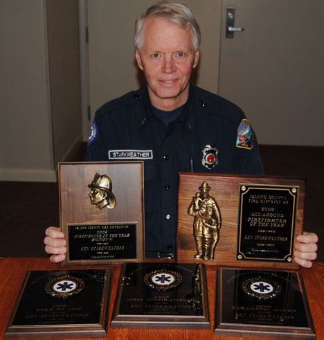 Ken Starkweather of the Freeland station displays two of the awards he received.