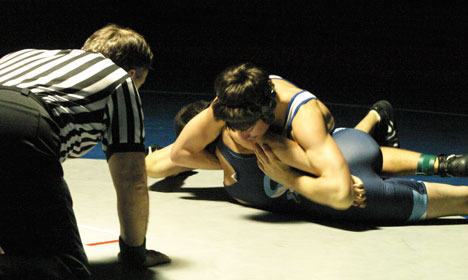 Falcon Ben Morgen tries his best to pin Sultan's David Huckabone under the watchful gaze of referee Eric Cannon on Thursday. Morgen won a technical victory with a 17-1 point spread.