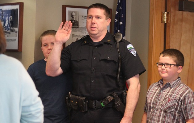 Ben Watanabe / The Record Dave Marks is sworn in as the chief of the Langley Police Department with his sons Joshua and Jacob on June 2.