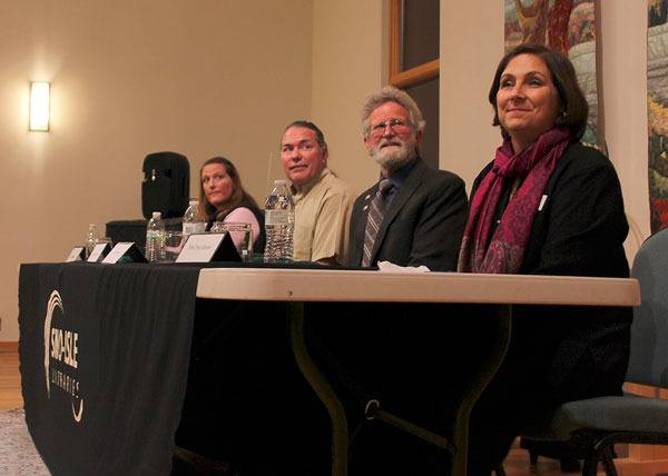 Candidates for the open district 1 and 2 county commissioner seats prepare to debate. Left to right: Jill Johnson