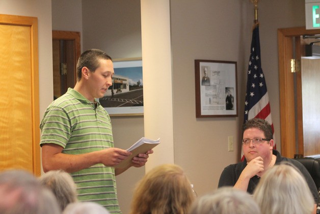 Joe Wierzbowski reads a statement to the Langley City Council in front of a packed council meeting room on July 6. He asked the council to allow his business to operate