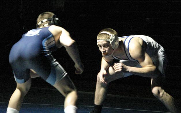 Falcon senior Evan Thompson eyes a takedown against Turk junior Kyle Weaver. Thompson won 9-8 and kept Weaver on the mat for the final 7 seconds to win the 145-pound match. South Whidbey beat Sultan 37-30 on Senior Night.