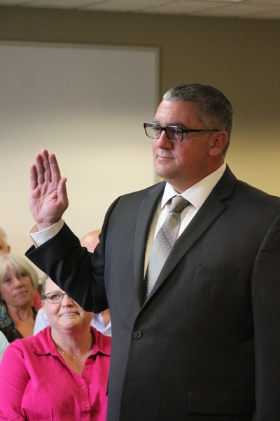 Michael Beech swears in as an officer of the Langley Police Department during a city council meeting Aug. 18. He joins the city after two decades as an Island County Sheriff’s Office deputy.