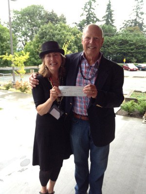 Whidbey Island Center for the Arts Foundation Chairman Earl Lasher presented a check to Stacie Burgua