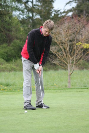 Falcon senior golfer Austin Drake tries to putt in for a bogey on the fourth hole at Useless Bay Golf and Country Club on April 22.