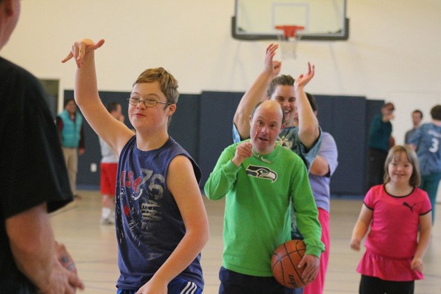 Andrew Bishop holds up his hot hand after making a basket during a recent Whidbey Wind practice. The South Whidbey-based Special Olympics teams won two gold medals last season.