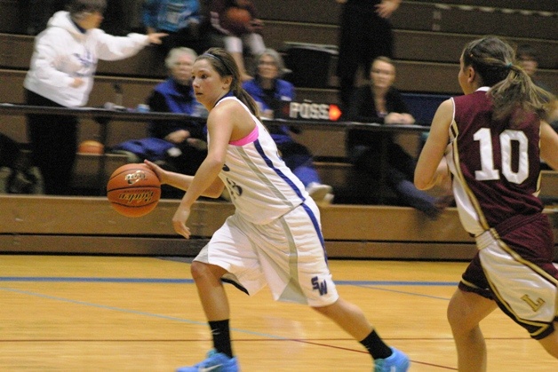 Falcon senior guard Brittany Wood breaks through Lakewood's full-court press defense at South Whidbey High School on Tuesday night. The Falcons won 60-52 in overtime.