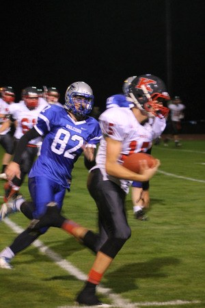 Falcon senior Mo Hamsa chases King’s sophomore quarterback Corey Kispert.