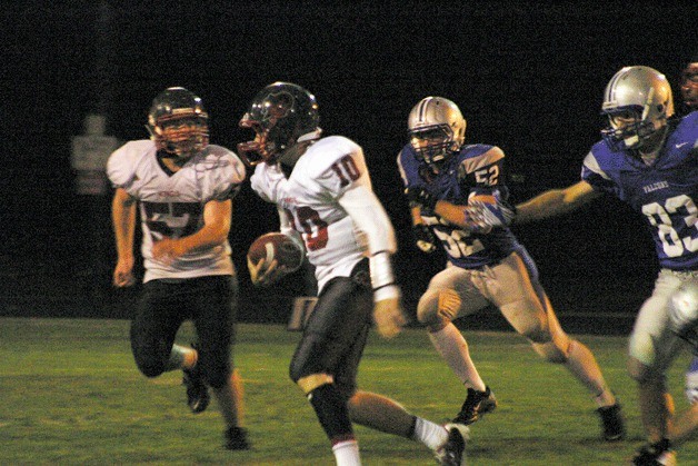 Knights quarterback Billy Green scrambles from Falcon defenders Mason Shoudy and Mitchell Hughes on Friday. King’s won 35-6 on several South Whidbey errors.