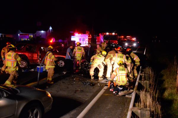 South Whidbey Fire/EMS firefighters work to free a man trapped in his vehicle following a head-on accident in Freeland Friday evening.