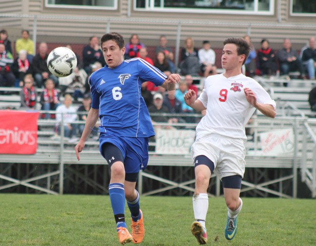 Falcon sophomore Lucas Leiberman fends off Wildcat senior defender James Bettag for the ball on a high bounce May 2 at Archbishop Murphy.