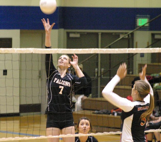 Falcon senior hitter Linden Firethorne tips over Wildcat junior hitter Beth Carlson on Tuesday night. Firethorne led all scorers with 17 kills in the Falcons’ fifth loss.