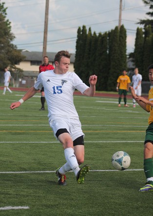 Falcon junior Andy Zisette takes a shot at the goal in the final two minutes of regulation against Quincy in the second round of the state 1A boys soccer tournament May 24 at Mariner High School. The shot was deflected