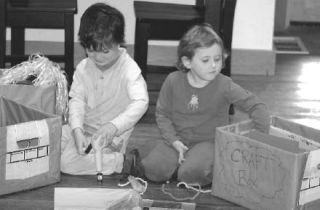 Kai Fawcett and Sage Hagopian spend some quality time checking out their “possibility boxes” at the Bayview Cash Store. Each box is filled with creative ways for children to entertain themselves when the television is off.