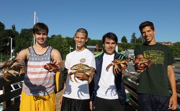 Things were slow and steady for these four young men crabbing at the Port of South Whidbey at Langley dock. From left are Brandon Brown