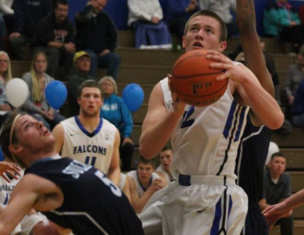 Falcon junior Parker Collins jumps between Turk senior Cooper Beucherie