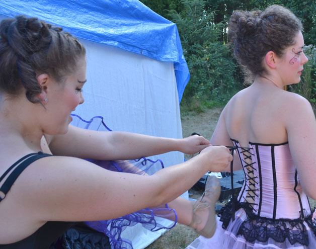 Laurel Livezy tightens Ahna Dunn-Wilder’s corset before returning to the stage.