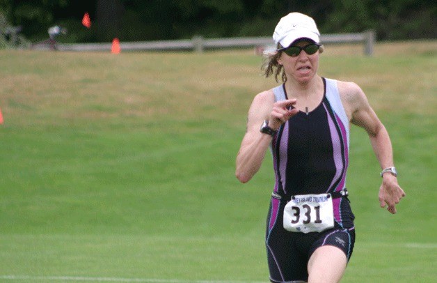 Stacia McInnes sprints toward the finish line at the Whidbey Island Triathlon. She won her fifth consecutive women’s title.