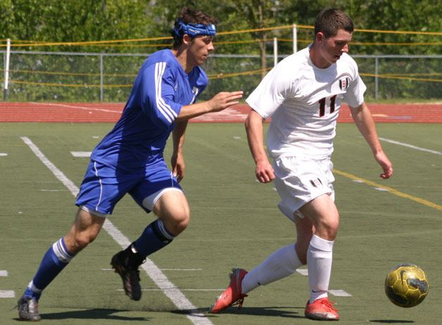 Bellingham senior defender Reed Welch pushes the ball across midfield to evade Falcon senior forward Noah Moeller. South Whidbey’s leading scorer was held to only a few shots on goal as Bellingham won 1-0 on a penalty kick in the 34th minute Saturday at Civic Stadium in Bellingham.