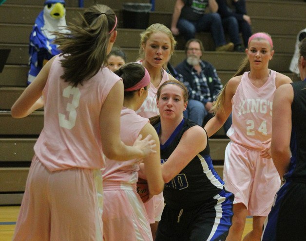 Falcon sophomore Emily Turpin fights for possession against King’s on Jan. 30.