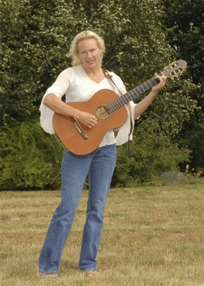 Alyssa Ingersoll enjoys the summer sun while she plays her guitar and sings her song "What love has done."