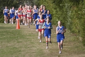 Langley Middle School cross country runners Marina Kovic and Lillianna Stelling head out of the woods on the way to first place during league finals.