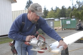 Garth Volpp of Ken Marsh Construction cuts some trim wood for the Greenbank Post Office renovation project.