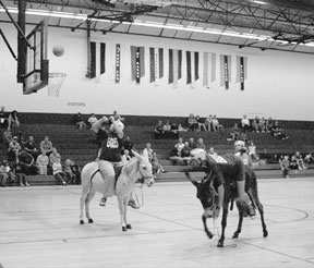 Eagles and Island County Fire District 3 volunteers play one of four tough quarters of donkey basketball Sunday as the firefighters head for their second victory in two years.However