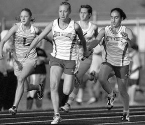 Claudia Gil-Osorio hands off to Nicole Mock in the 4x100 relay at last week's NCC championship at Lynden Christian. The team was a winner for the second week in a row at Saturday's district championships in Sultan.