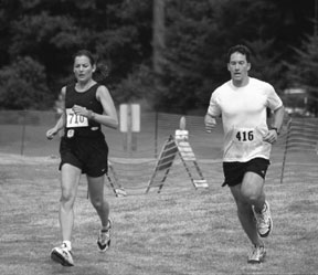 Ryan Montecucco (416) of Seattle finishes the Whidbey Island Triathlon Saturday in a sprint against a team runner.