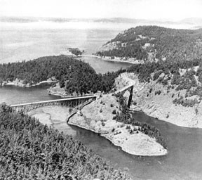 This aerial photo in the book shows something many visitors miss -- there are two bridges. Deception Pass Bridge is on the left and Canoe Pass Bridge is on the right. In the center